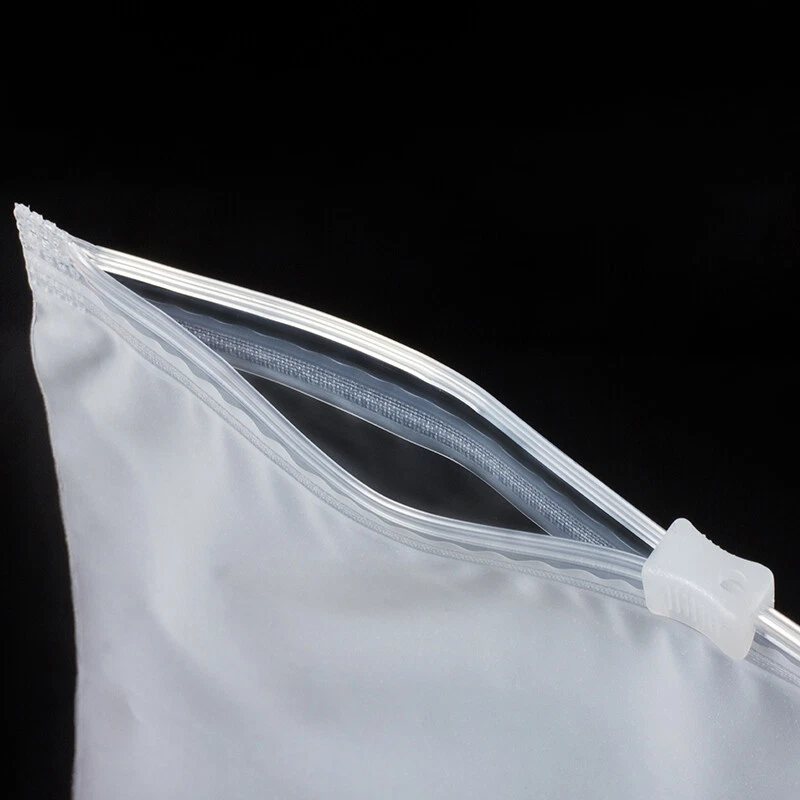 Pouch with a slider zipper partly open